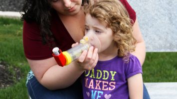 Joyce Kelso gives her 3 year old daughter, Karma, asthma medication through an inhaler in Columbus, Ohio.
